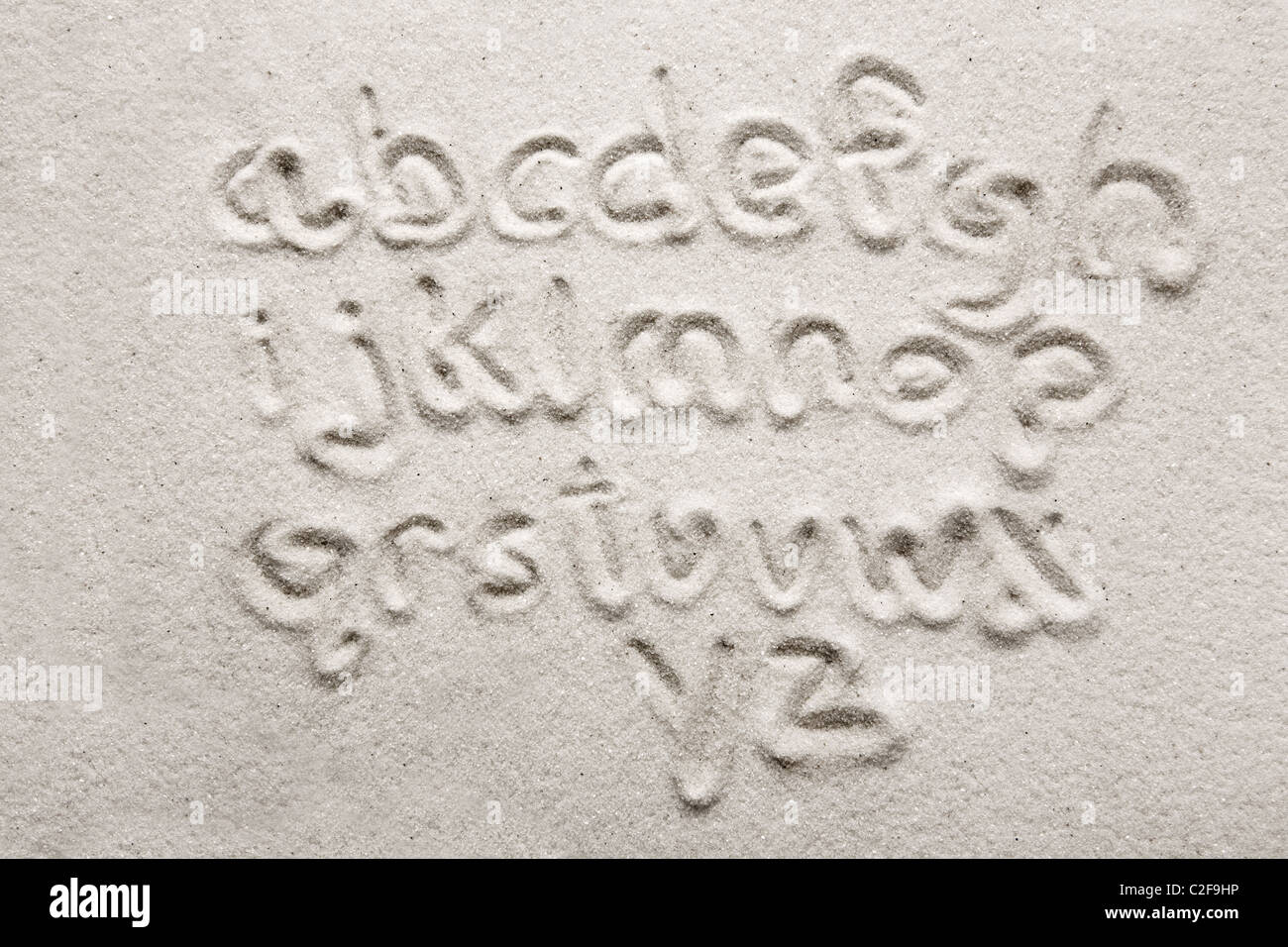 Custodia inferiore alfabeto scritto in sabbia - un attrezzo di designer Foto Stock