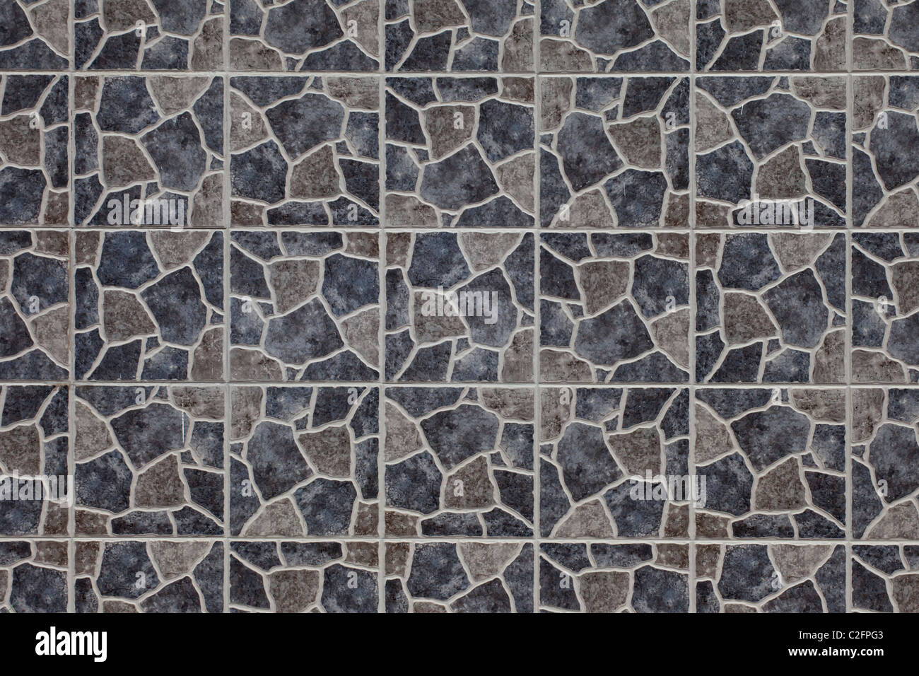 Una parete di piastrelle in texture disattivato grigio e marrone Foto Stock