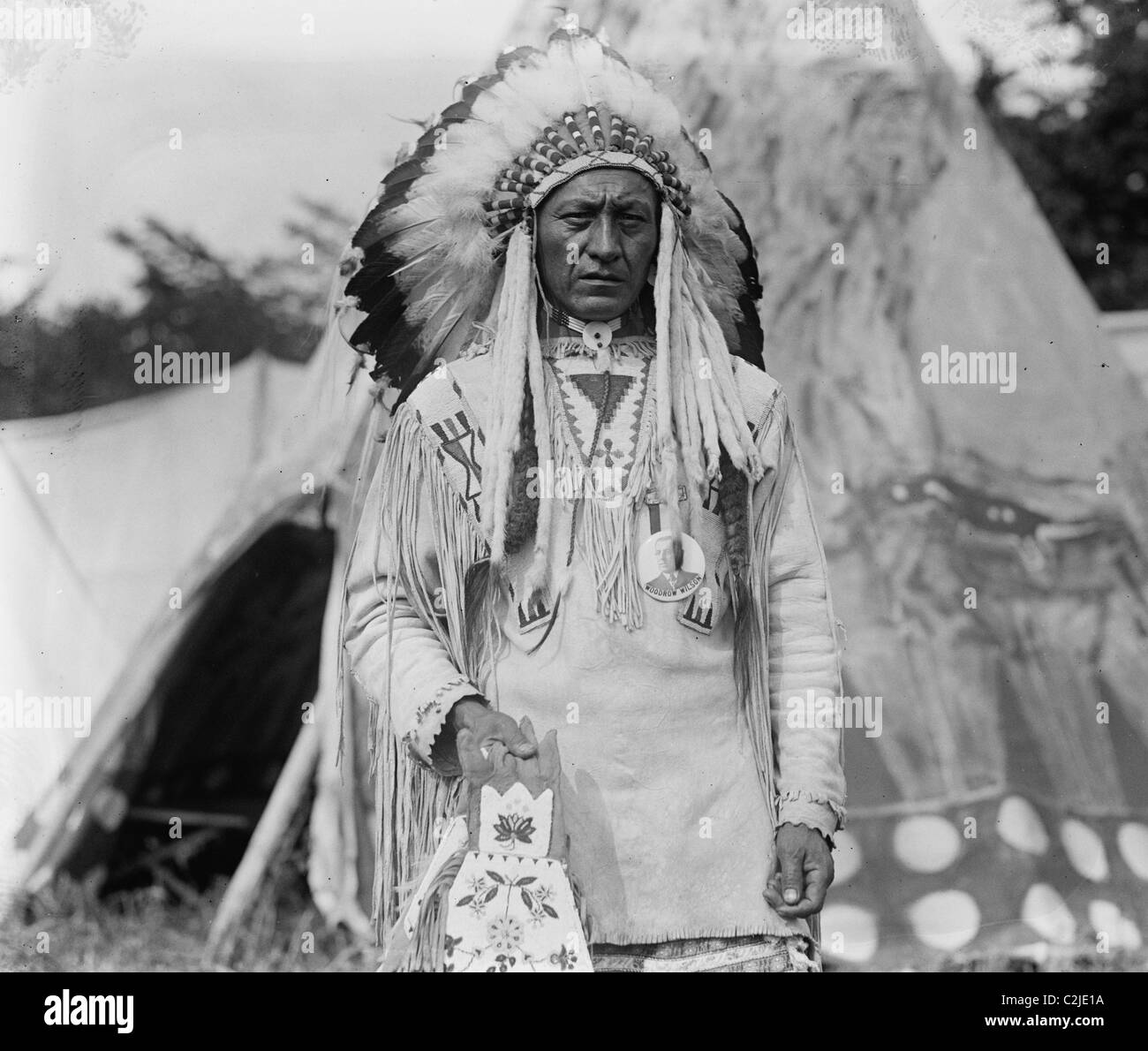 Capo nativo americano in abiti tradizionali e selvaggina di penna cofano Foto Stock