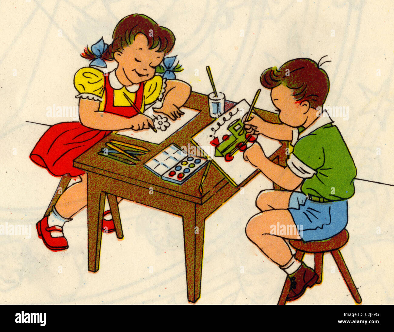 Boy & Girl disegnare immagini a una tabella Foto Stock