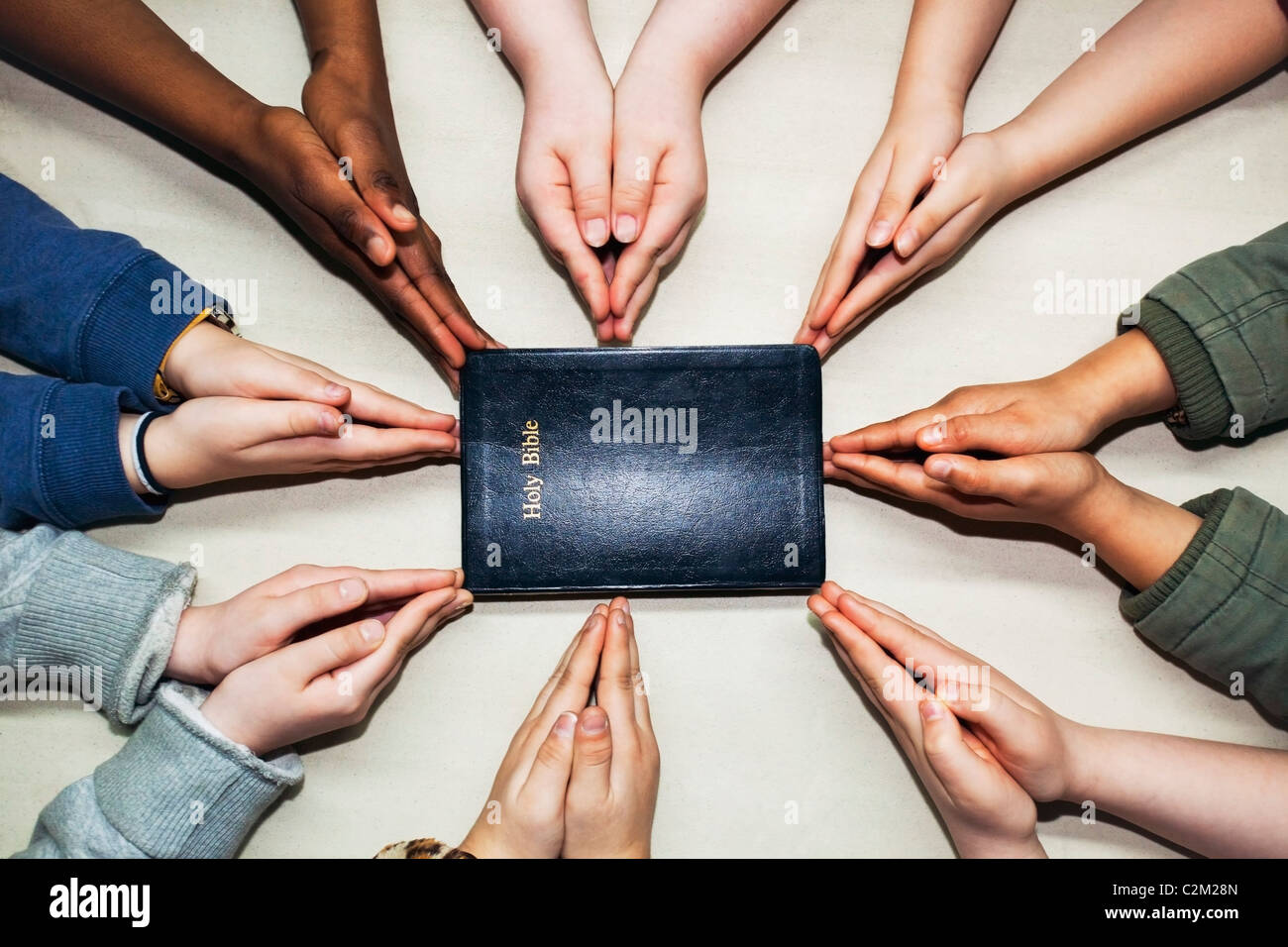 Pregando mani puntando a una Bibbia Foto Stock