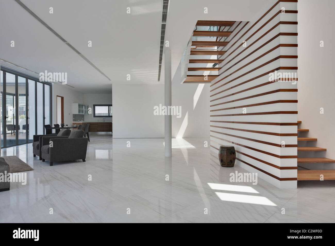 Casa moderna. Bianco spazioso salotto aperto e scale in legno Foto Stock