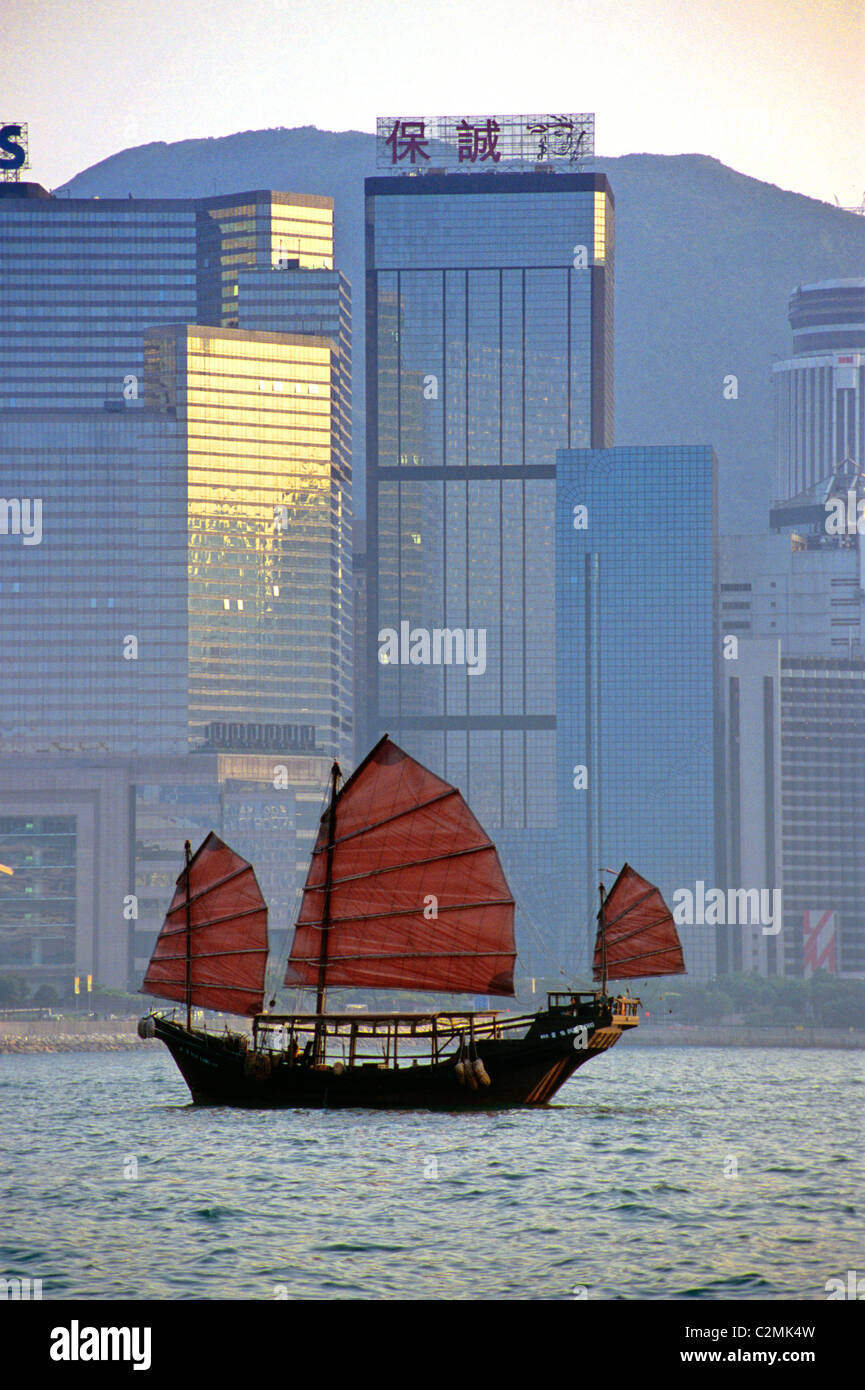 Hong Kong, giunca Cinese vela da Isola di Hong Kong skyline. Foto Stock