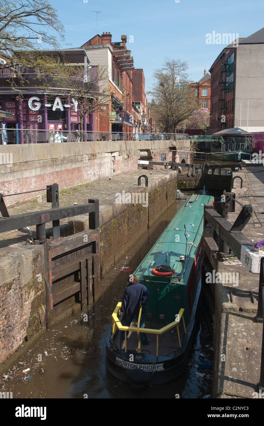 Canal Boat andando entrare in blocco sul Rochdale canal nel villaggio del distretto centrale di Manchester. Foto Stock