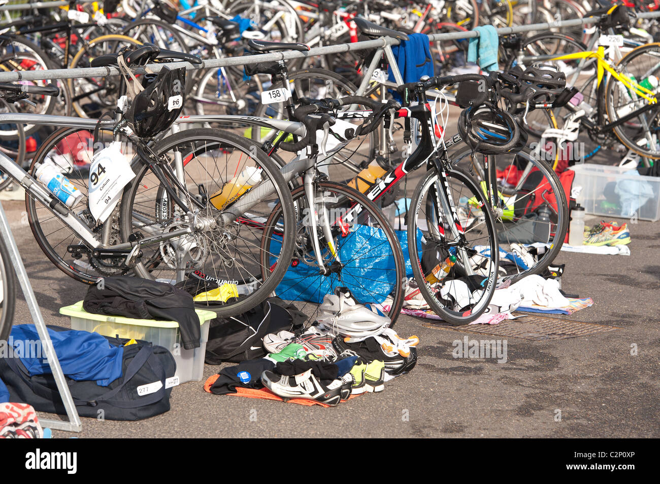 Zona di transizione per competere tri atleti di triathlon con il kit di cui sei pronto per giro dopo una nuotata Foto Stock