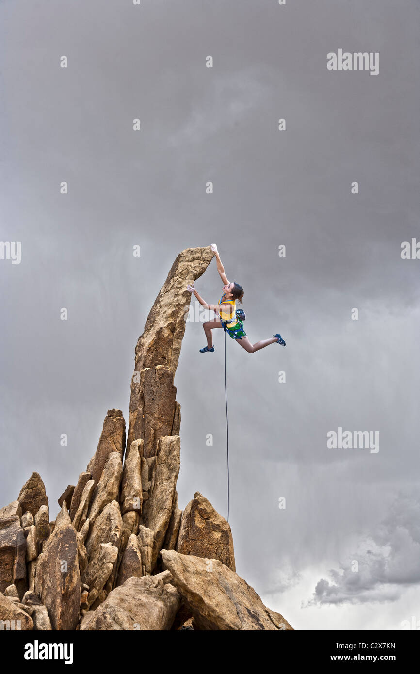 Female rock climbing penzolante dal vertice. Foto Stock