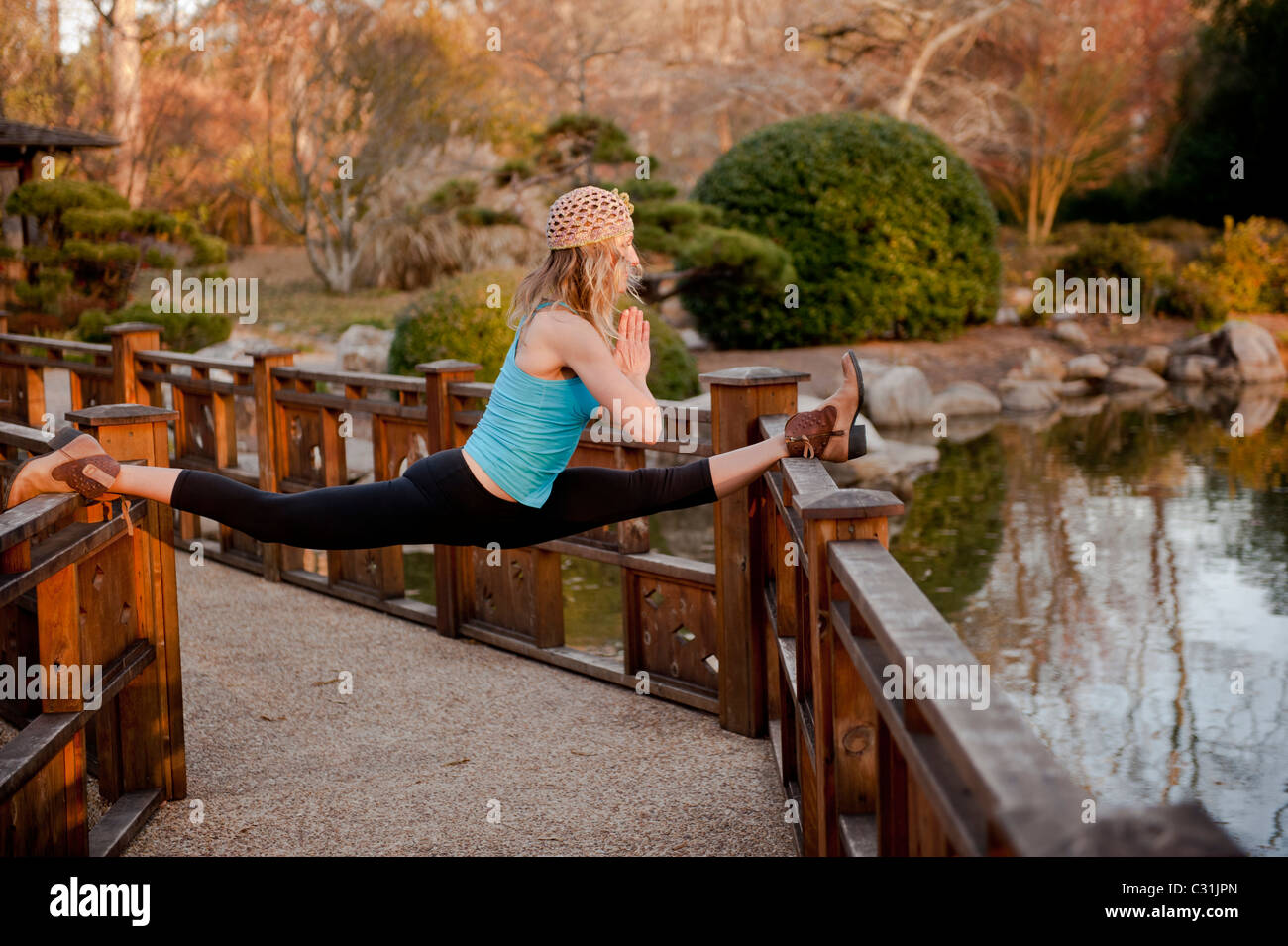 Una donna facendo posture yoga in ambiente esterno. Foto Stock