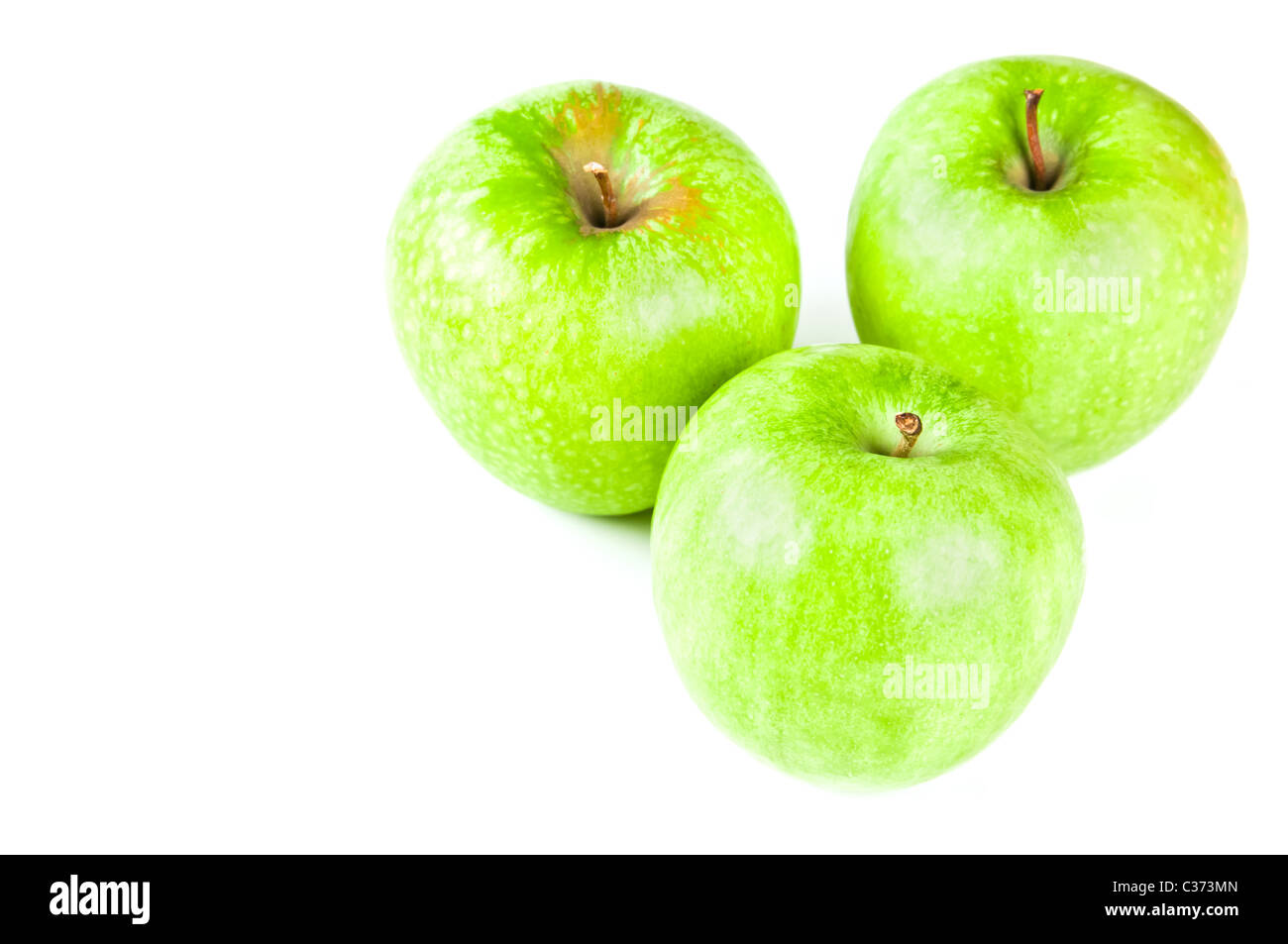 Tre mele verdi Foto Stock