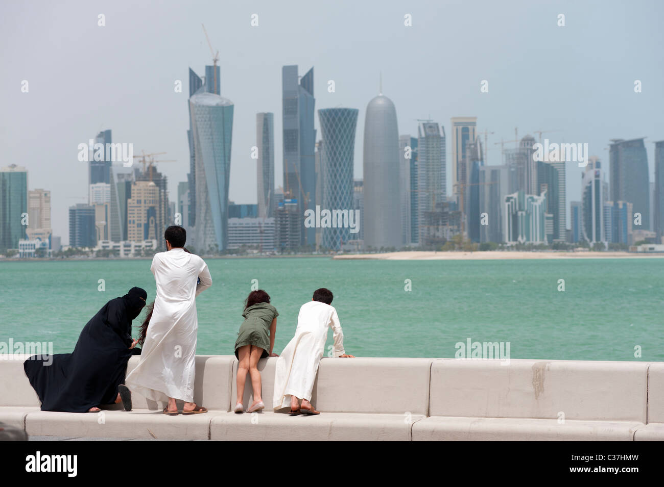 Alto e moderno ufficio torri formano skyline di Doha in Qatar con la famiglia sulla Corniche Foto Stock