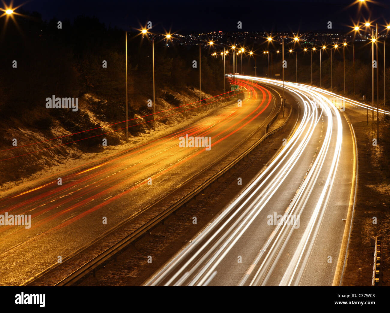 Traffico sentieri di luce visibile di notte sulla trafficata A90 a doppia carreggiata che conduce alla città di Aberdeen, Scozia, Regno Unito Foto Stock