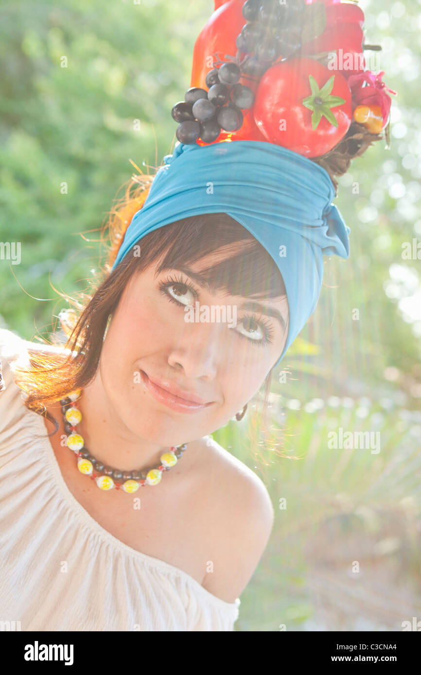 Giovane donna che indossa la frutta hat Foto Stock