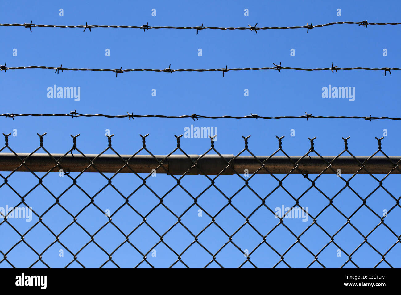 Maglia di catena e filo spinato top con cielo blu sullo sfondo Foto Stock