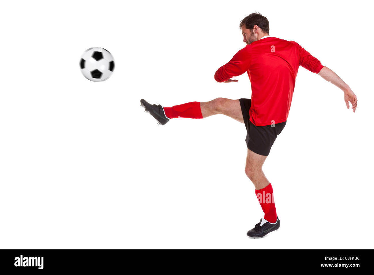 Foto di un calciatore o giocatore di calcio ritagliata su uno sfondo bianco,. Foto Stock