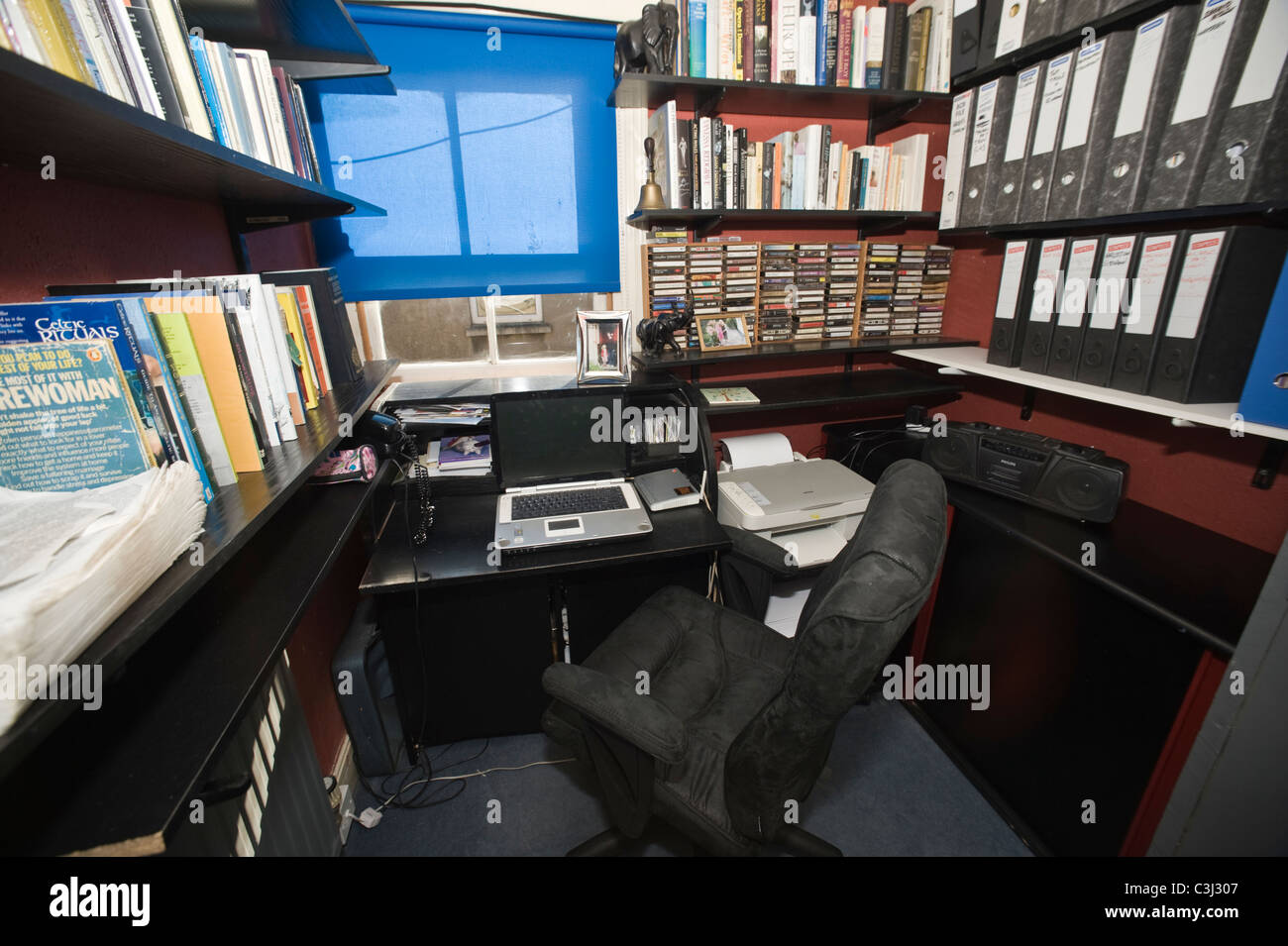 Piccola writer's studio con scrivania sedia ufficio computer portatile i file di librerie etc Foto Stock
