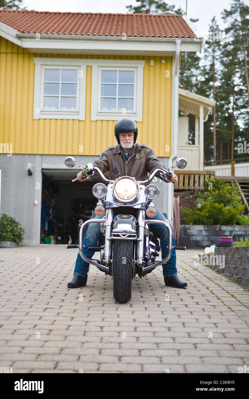 L'uomo su vintage moto nel viale di accesso Foto Stock