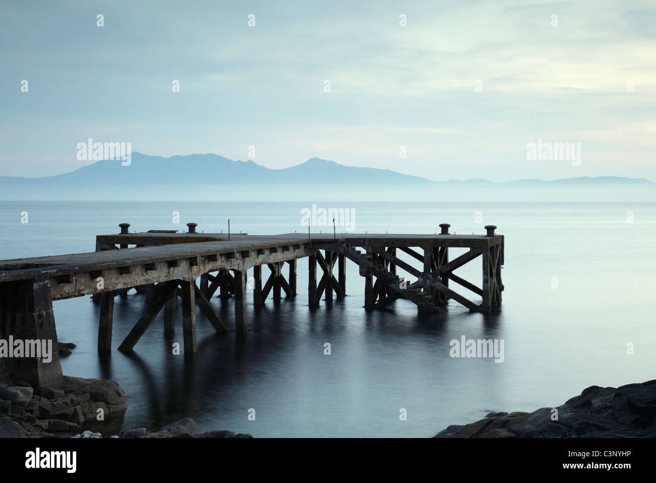 Portencross Pier visto dal percorso costiero Ayrshire con l'isola di Arran nel Firth di Clyde, Nord Ayrshire, West Coast of Scotland, Regno Unito Foto Stock