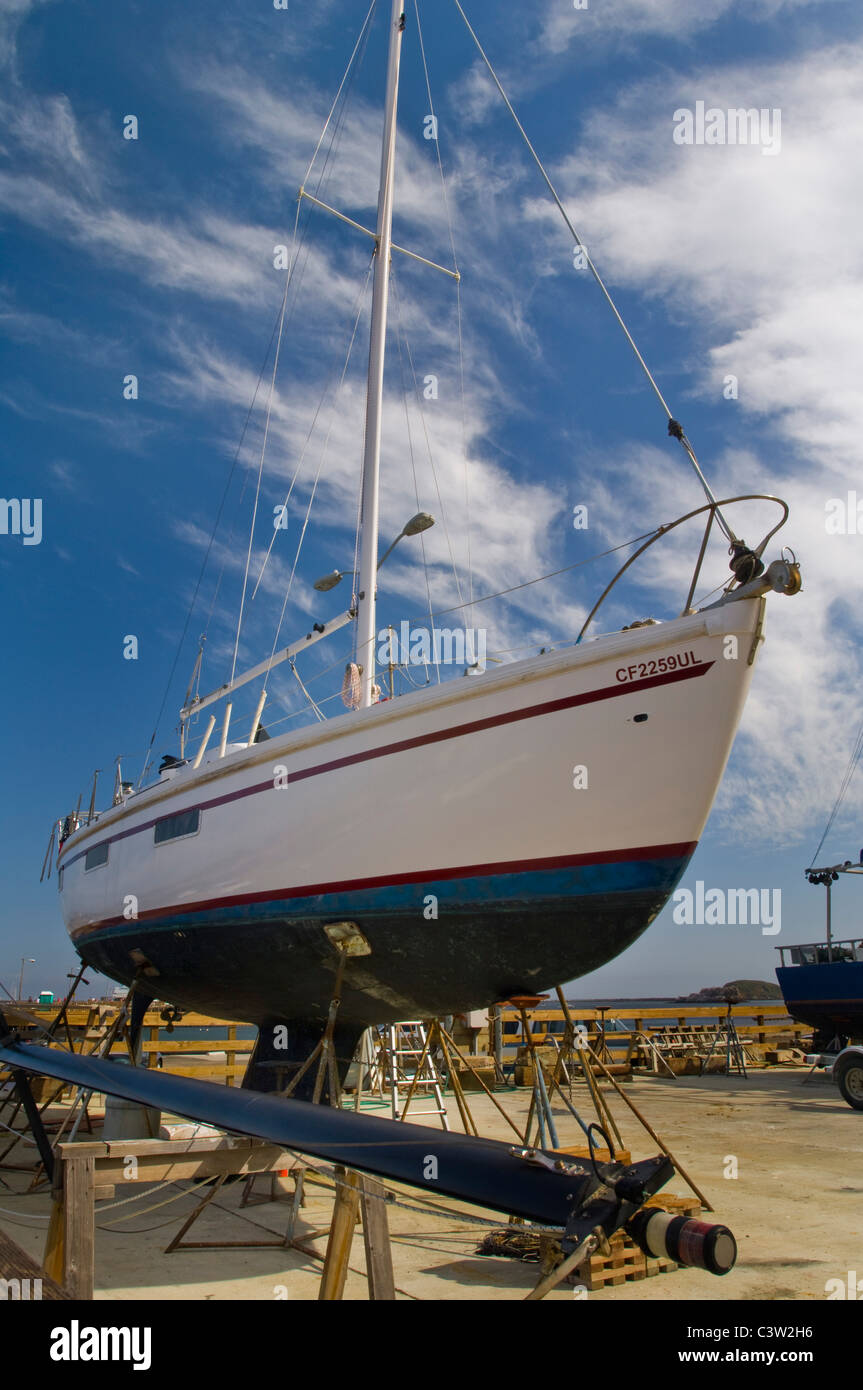 Barca a vela su cavalletti in cantiere a Porto San Luis, San Luis Obispo County, California Foto Stock