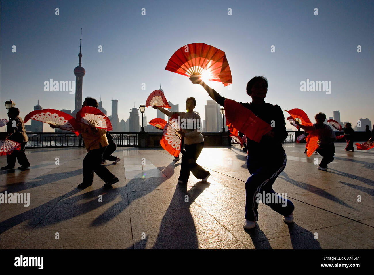 Cina. Shanghai. Il Bund. Background: Skyline di Pudong (quartiere commerciale) facendo esercizi del mattino (Tai Chi). Foto Stock