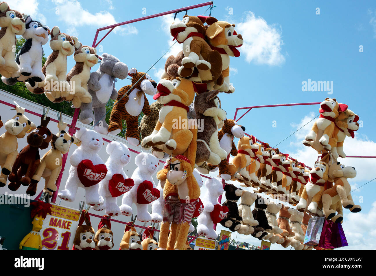 Peluche appeso e sui ripiani su un grande spiazzo davanti a un cavalletto e vintage rally. Foto Stock