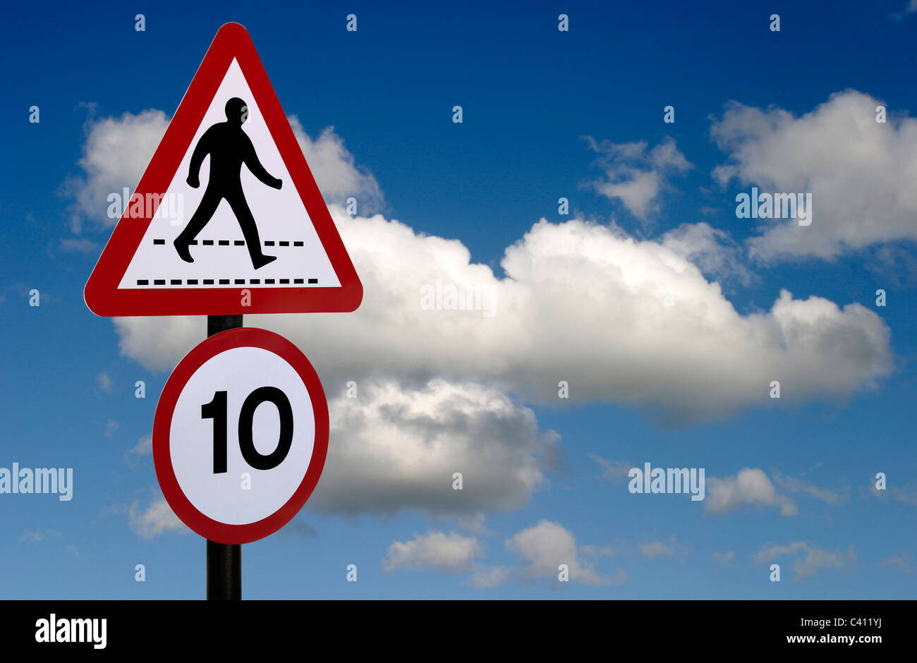 Passeggiata pedonale segno con 10 km/h il limite massimo di velocità di avvertimento. Segno è contro un cielo blu con nuvole bianche Foto Stock