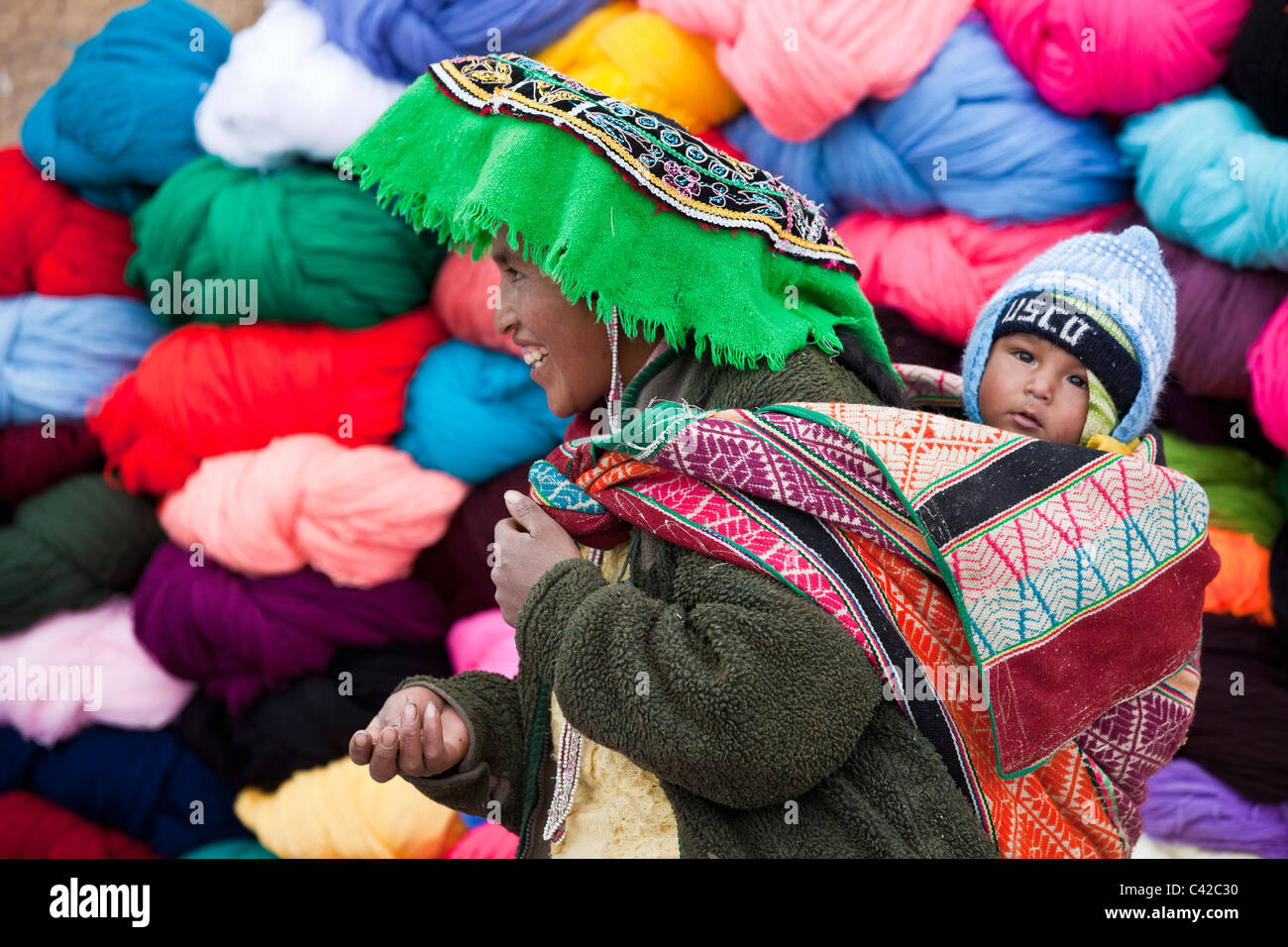 Il Perù, Huancarani, donna e bambino di fronte di lana per la vendita sul mercato. Foto Stock