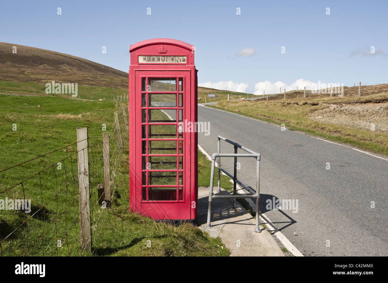 Voe, Northmavine, Isole Shetland Scozia, Regno Unito, Europa. Via unica strada di campagna e telefono rosso kiosk. Foto Stock