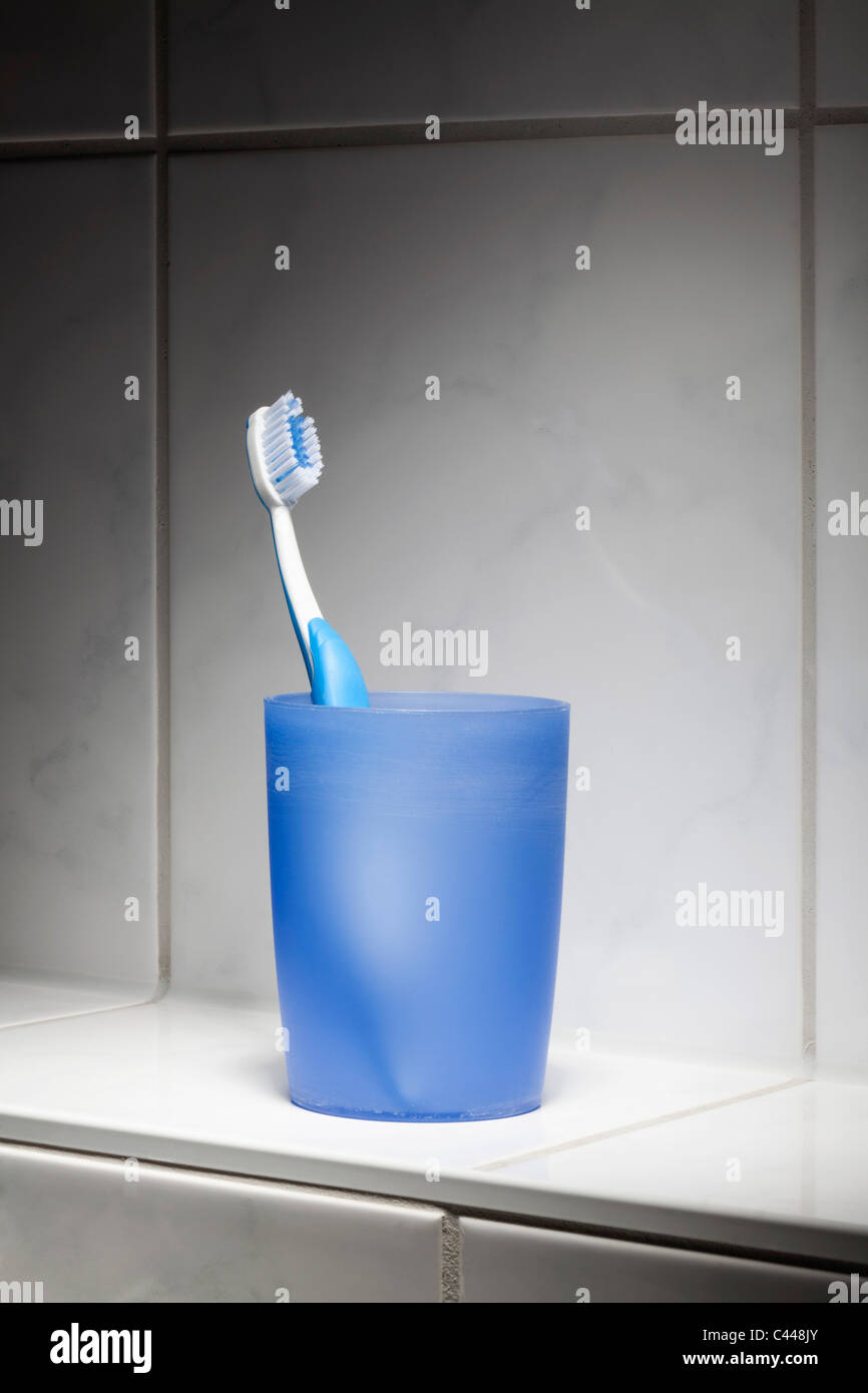 Uno spazzolino da denti in una tazza Foto Stock