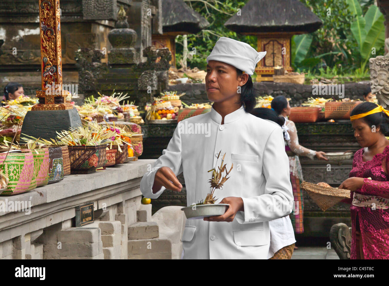 Un sacerdote Indù rende offerte presso la pura Tirta Empul tempio complesso durante il GALUNGAN FESTIVAL - TAMPAKSIRING, BALI Foto Stock