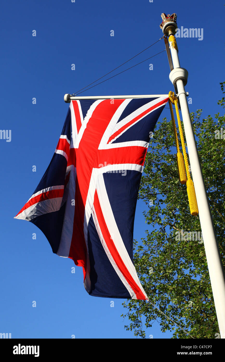 La bandiera britannica, l'Unione Jack, volare su una corona sormontata pennone sul Mall, Londra. Foto Stock