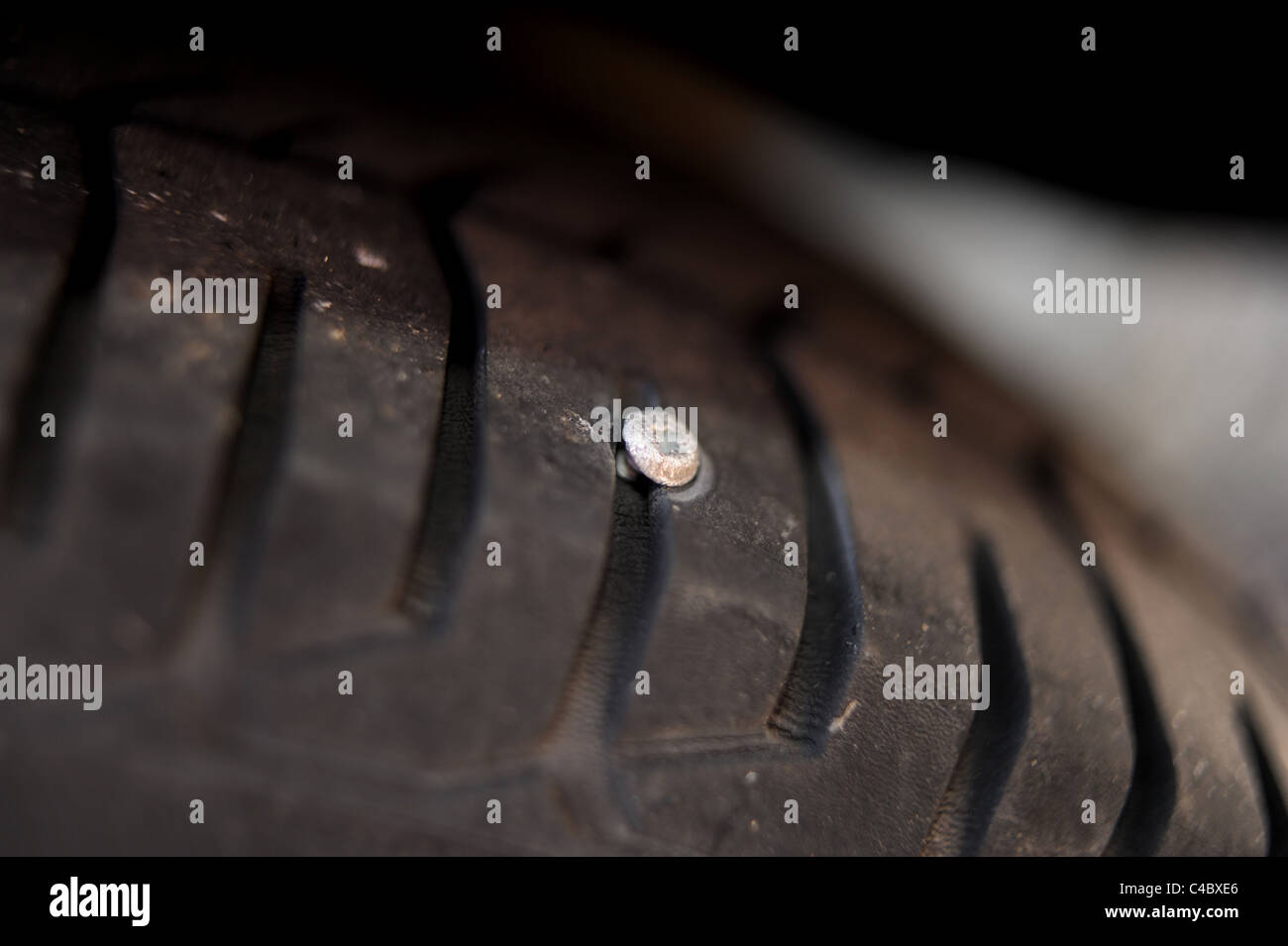 Un chiodo o vite che è andato in o attraverso un veicolo pneumatico provocando una foratura UK road Foto Stock