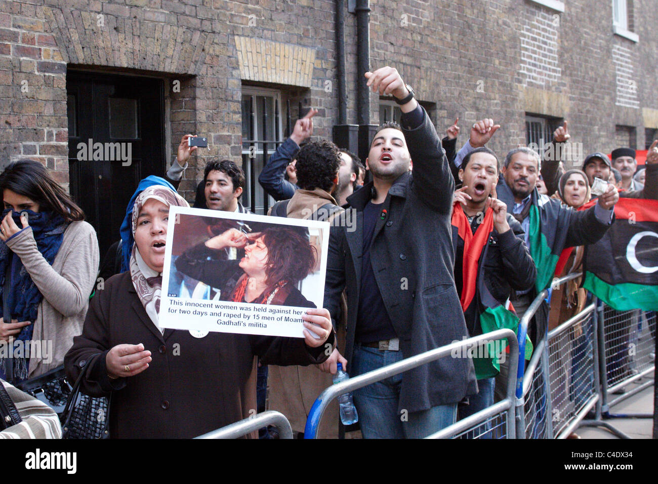 Anti-Gaddafi manifestanti si scontrano con i suoi sostenitori al di fuori di una conferenza dei paesi applicando una no-fly zone Foto Stock