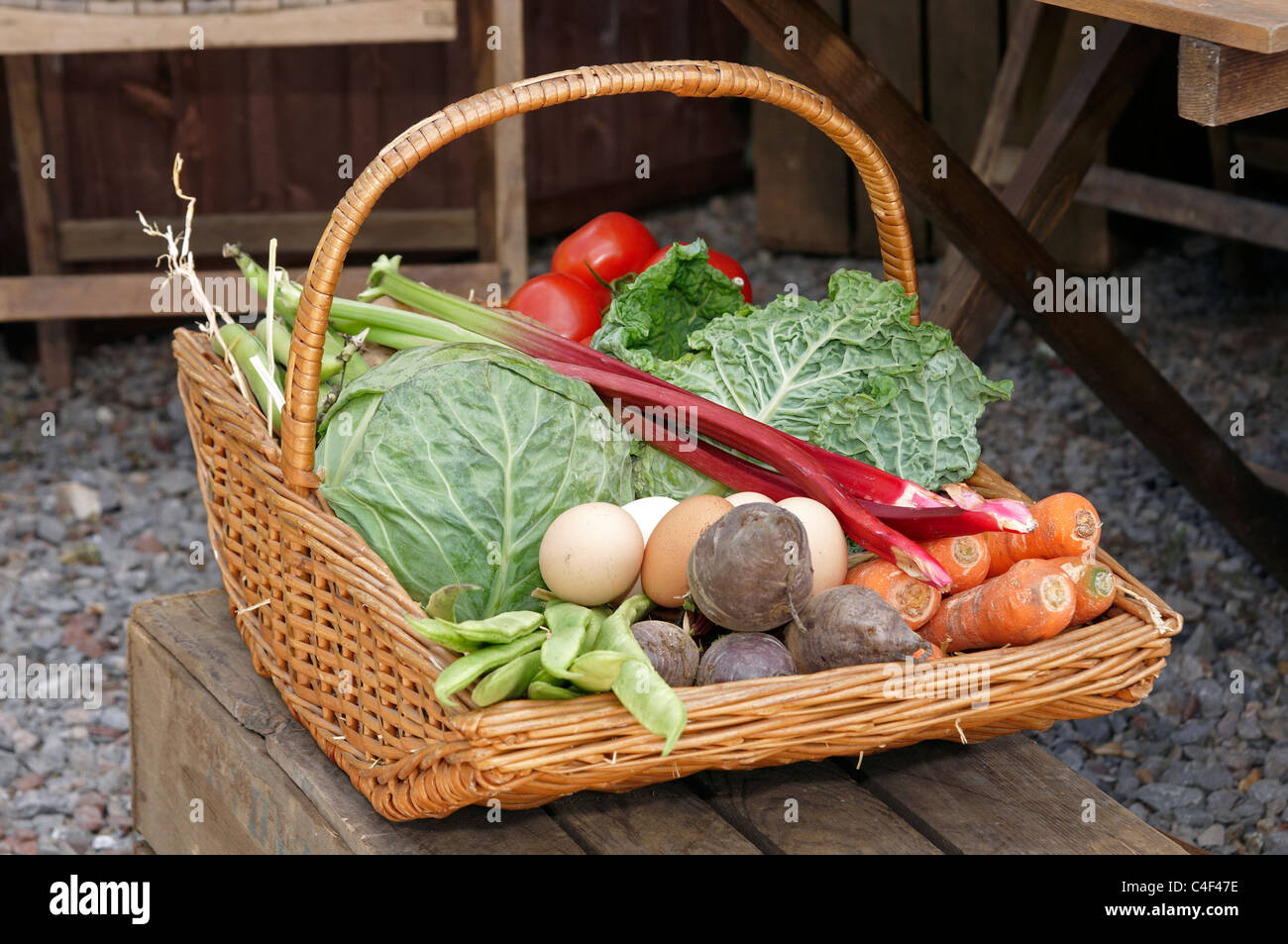 Articoli di vimini giardinieri cesto o trug con verdure fresche dal giardino e uova dimostrando 'DIG per la vittoria" a WW2 rievocazione. Foto Stock