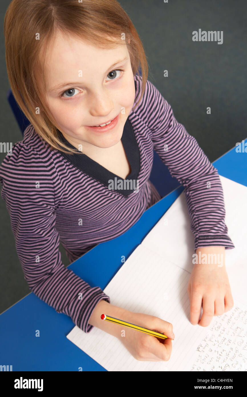 Schoolgirl studiare in aula Foto Stock