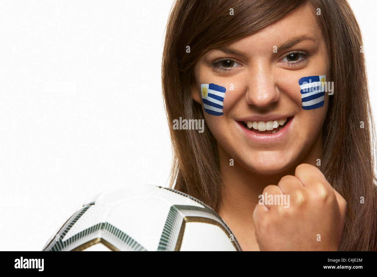 Femmina giovane tifoso di calcio con bandiera uruguayano dipinto sul volto Foto Stock