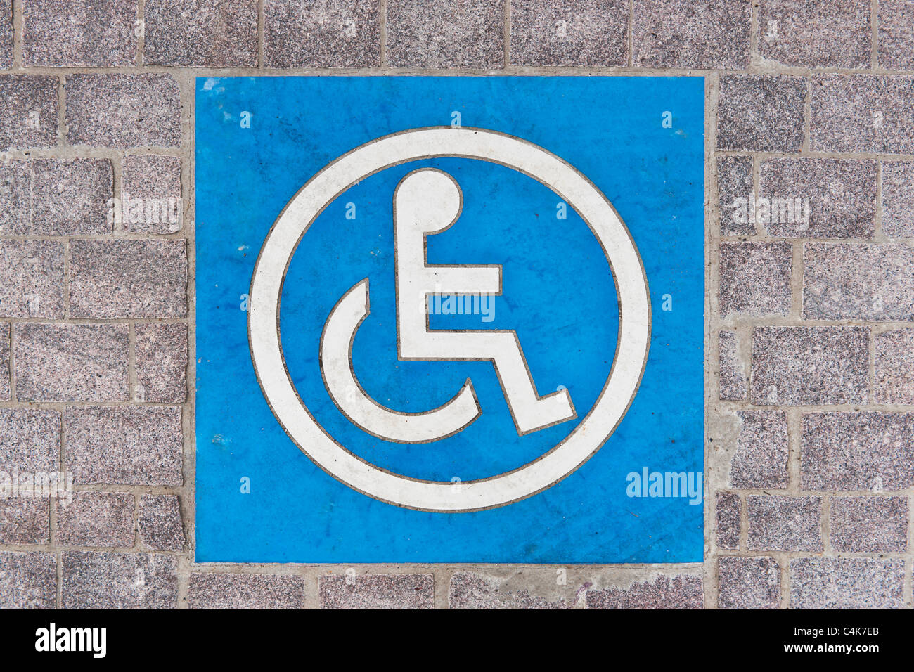 Symbol für einen Behindertenparkplatz auf der Straße | Simbolo per disabili permessi di parcheggio sulla strada Foto Stock