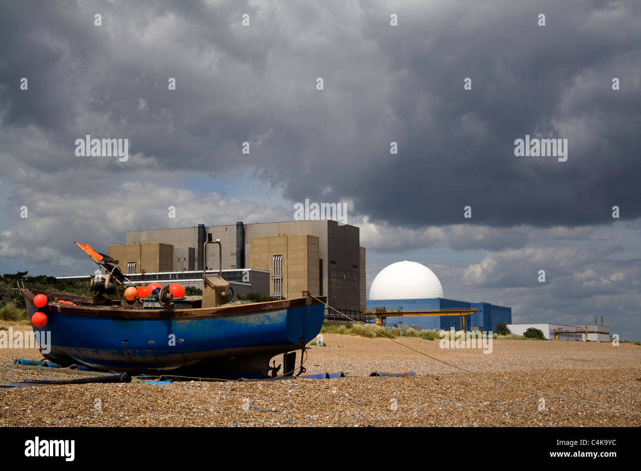 Una barca da pesca è spiaggiata al di sotto delle due centrali nucleari di Sizewell nel Suffolk. Foto Stock