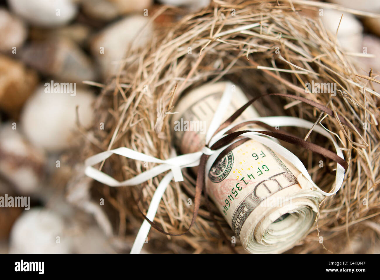 Un rotolo di soldi legato in su che illustra il risparmio o la pianificazione futura Foto Stock