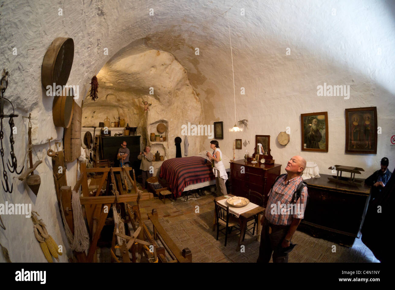 Italia - storica casa grotta nei Sassi Caveoso di Matera. Casa Grotta di Vico Solitaro. I turisti studiare i dettagli. Foto Stock