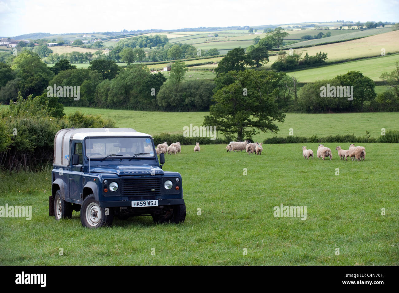 Gli agricoltori blue Land Rover in campo. Devon. Foto Stock
