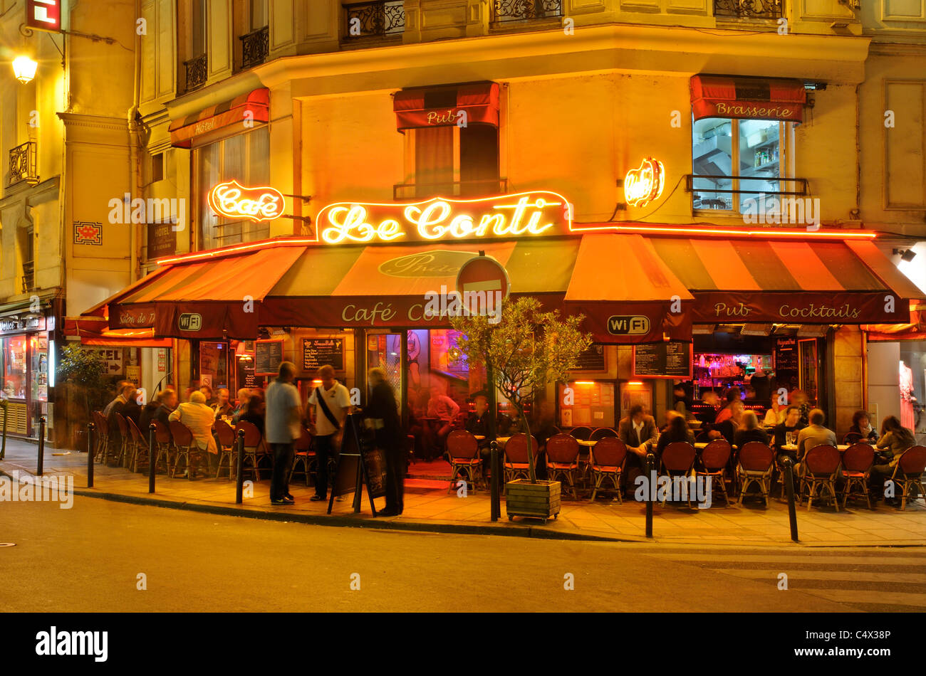 La gente seduta al di fuori di un ristorante nell'area di St Germain di Parigi di notte Foto Stock