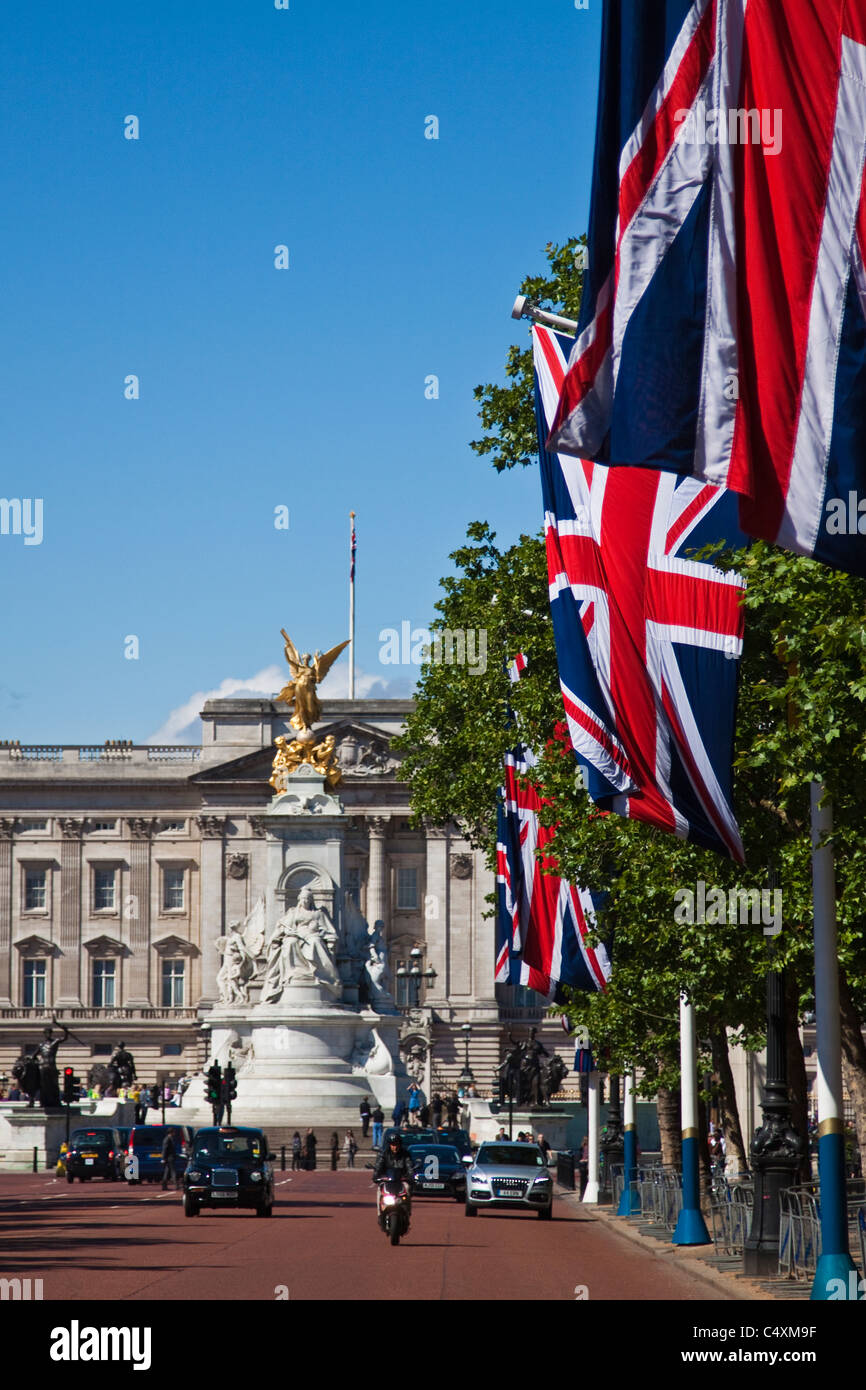 Queen Victoria Memorial di fronte a Buckingham palace con unione bandiere sul Mall Foto Stock