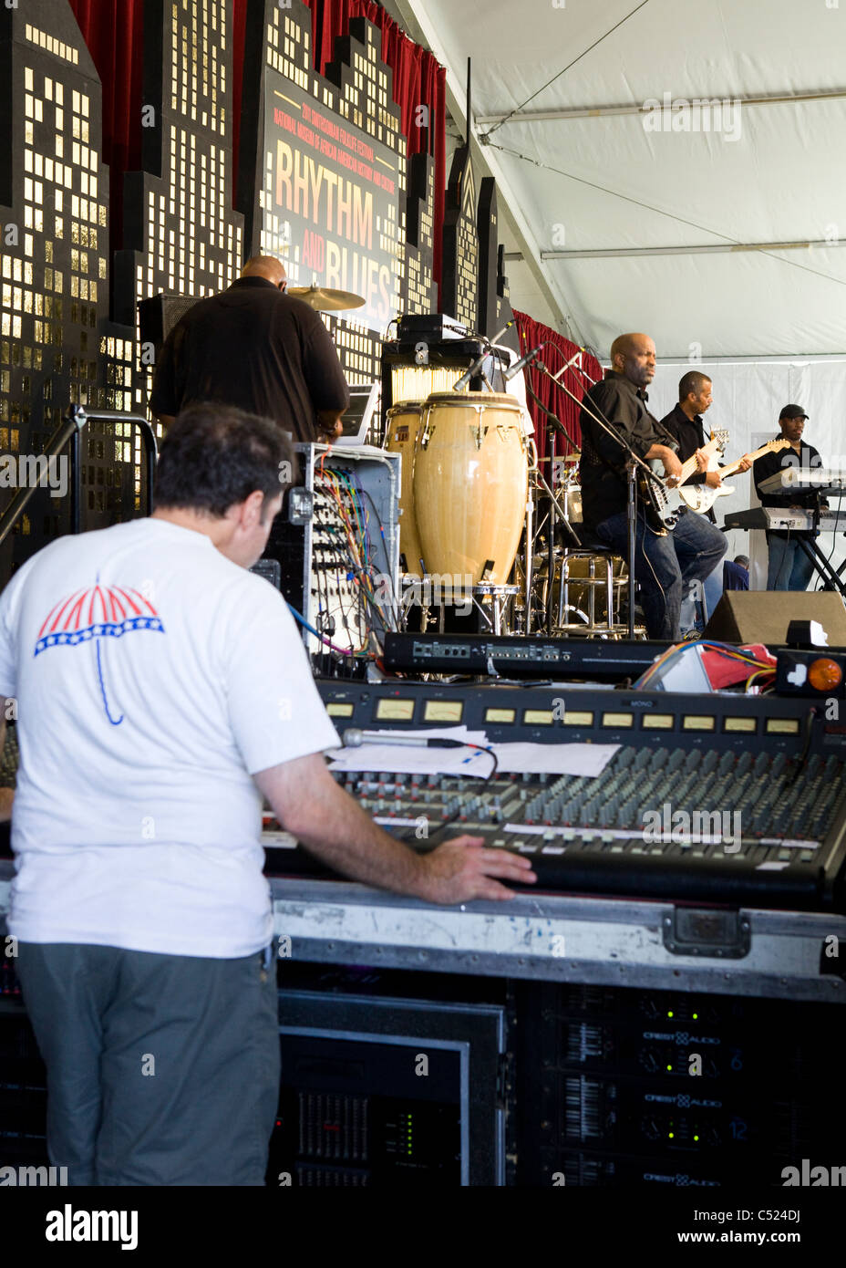 Tecnico audio utilizzando un miscelatore accanto alla fase Foto Stock