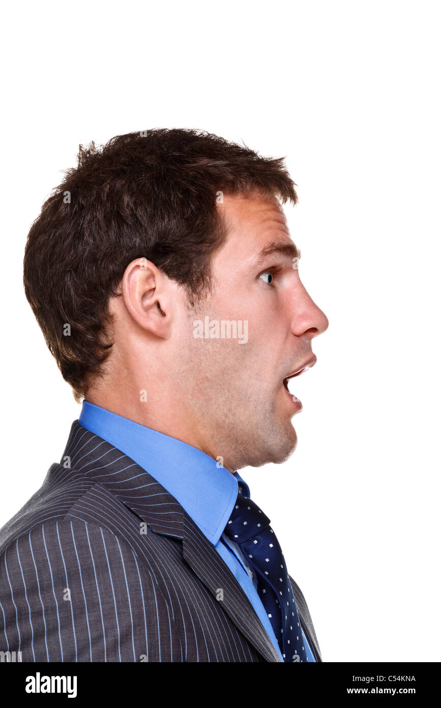 Foto di un imprenditore con un espressione sconvolta sulla sua faccia, lato headshot isolato su uno sfondo bianco. Parte di una serie. Foto Stock