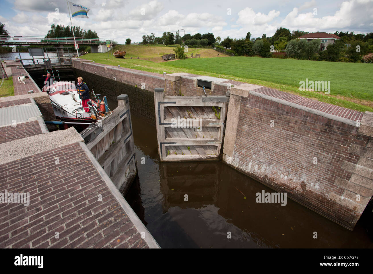 Nei Paesi Bassi, vicino Bodegraven, Meije fiume. Piacere yacht in attesa nella serratura. Foto Stock