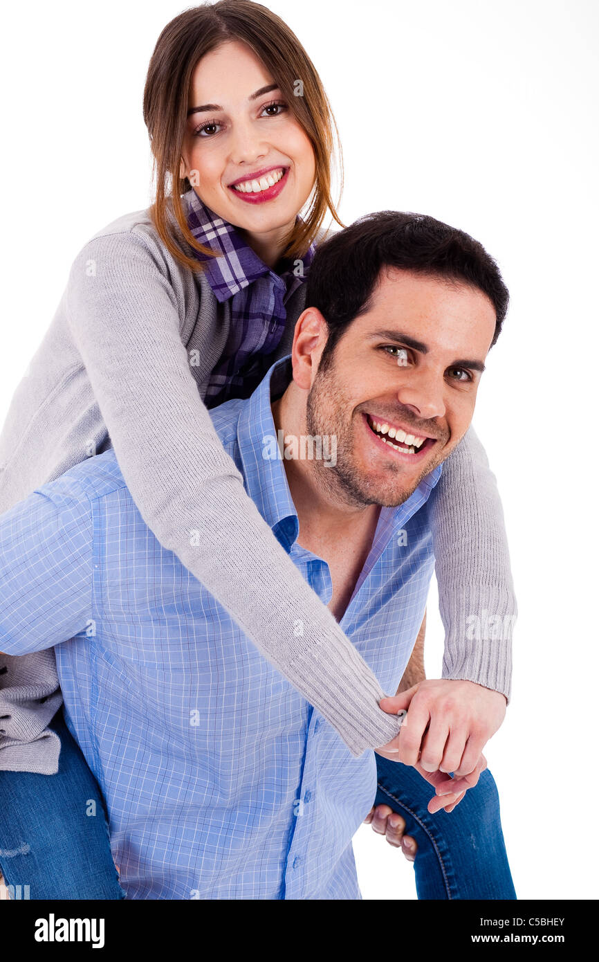 Allegro coppia giovane piggybacking su sfondo bianco Foto Stock