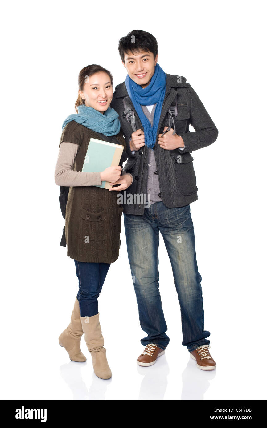Due compagni di classe sorridente, sfondo bianco Foto Stock