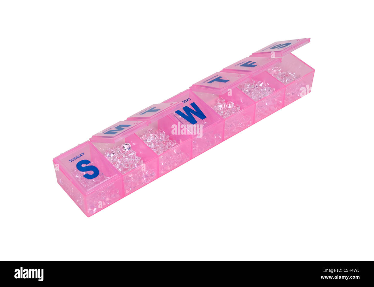 La distribuzione della ricchezza rappresentata da una pillola quotidiana minder riempito con diamanti per conveniente distribuzione - percorso incluso Foto Stock