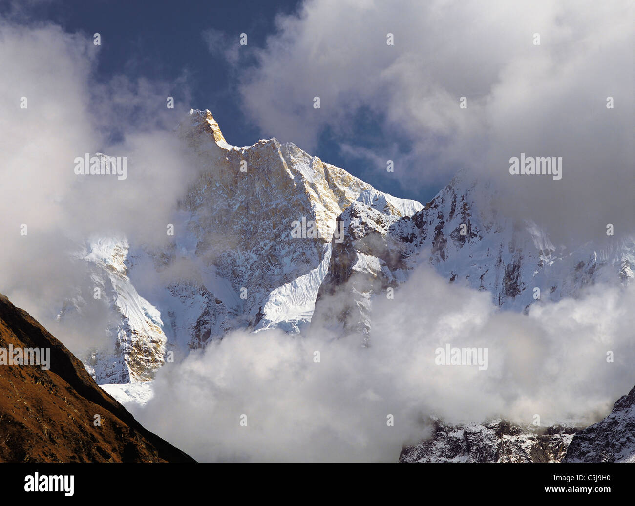 Pomeriggio di nebbia e nuvole si raccolgono intorno al picco drammatico di Jannu nella regione Kangchenjunga dell est del Nepal Foto Stock