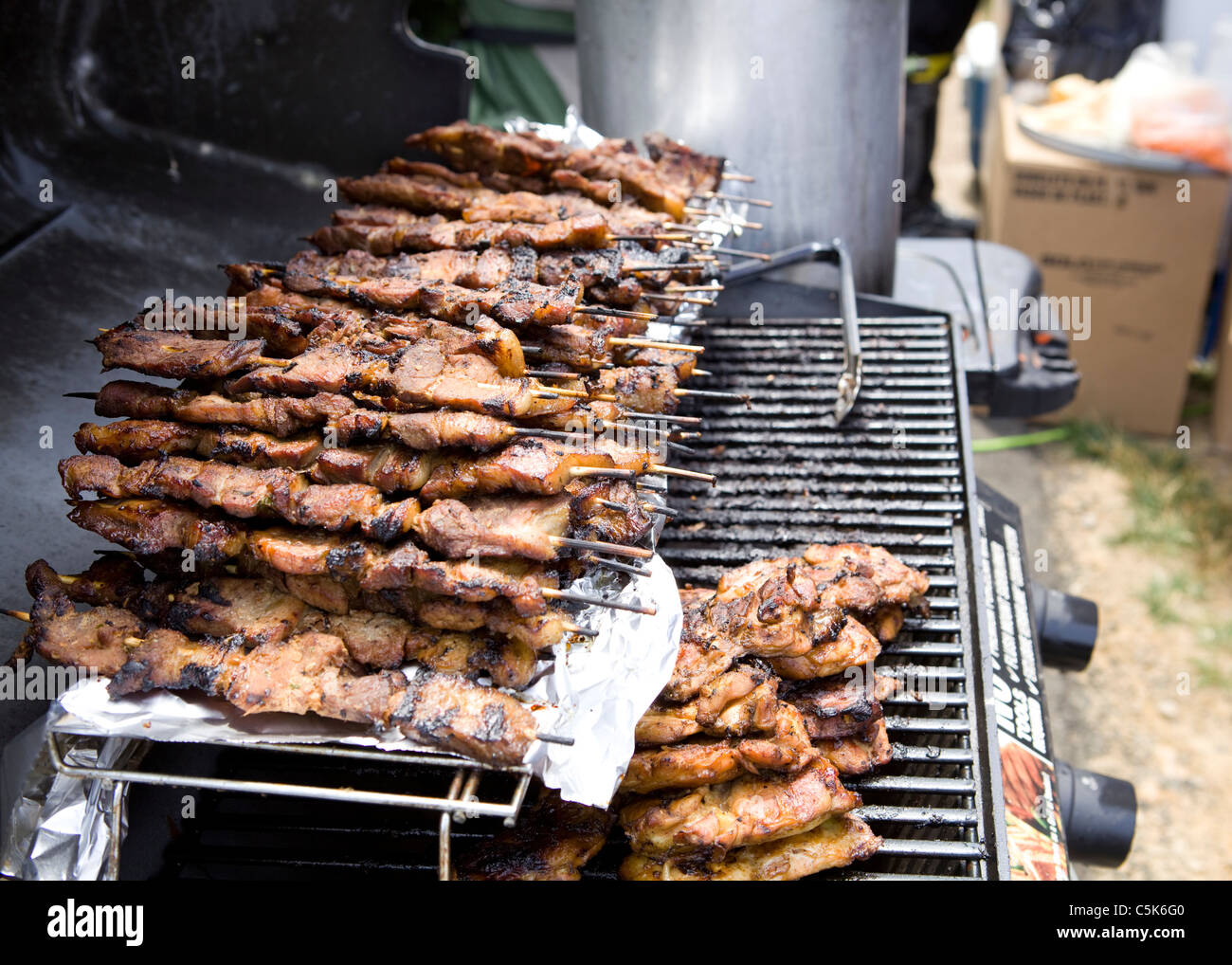 Carni bovine barbecue spiedini tenere in caldo sulla rastrelliera superiore del grill Foto Stock