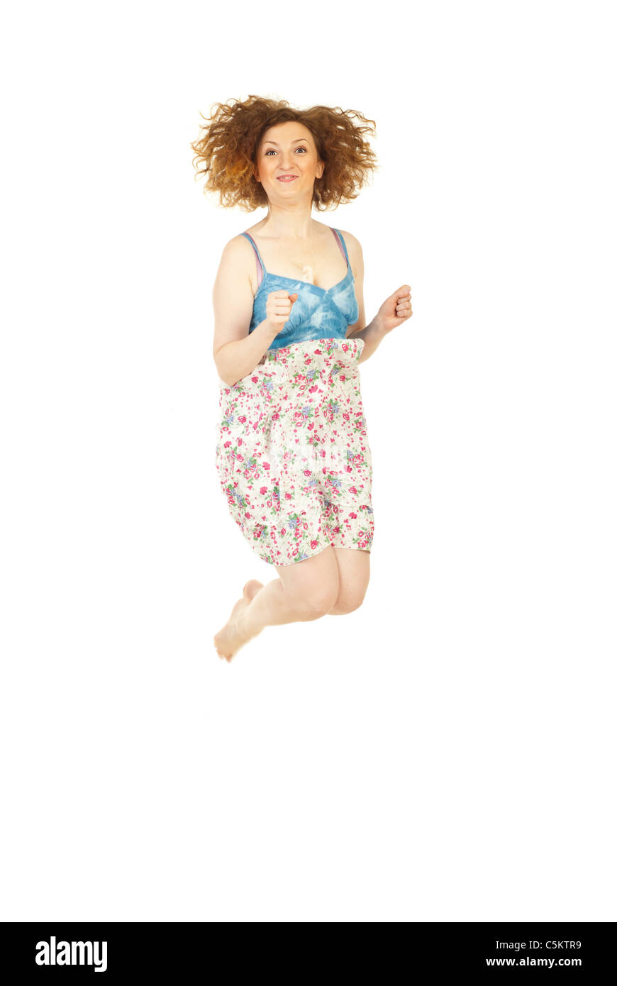 Felice redhead donna jumping isolati su sfondo bianco Foto Stock